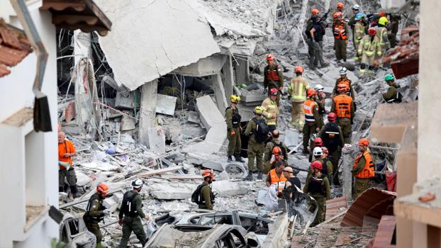 IMAGE: Rescue personnel at an impact site in Rishon LeZion following an Iranian missile attack on Israel. Photograph: Ronen Zvulun/Reuters