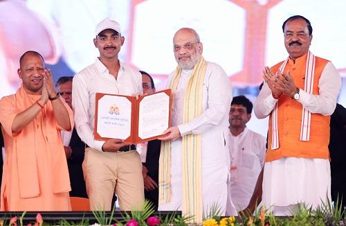 Union Home Minister Amit Shah presents an appointment letter to a newly selected cop in Lucknow on Sunday./@AmitShah X/ANI Photo