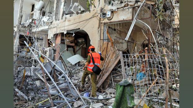 A rescuer works at a bombed site in Israel. Ammar Awad/Reuters