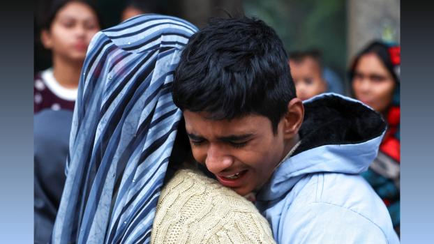 The son of blast victim Dinesh Misra weeps. Anushree Fadnavis/Reuters