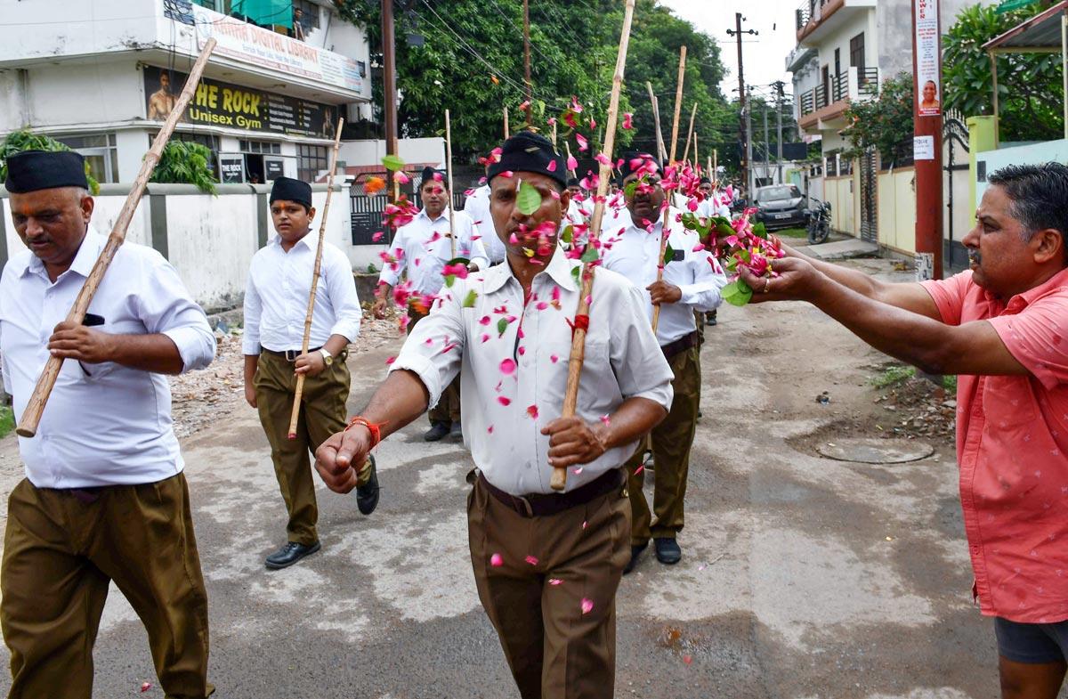 RSS volunteers march along a road during Path Sanchalan on the occasion of Vijayadashami to mark the Dussehra festival