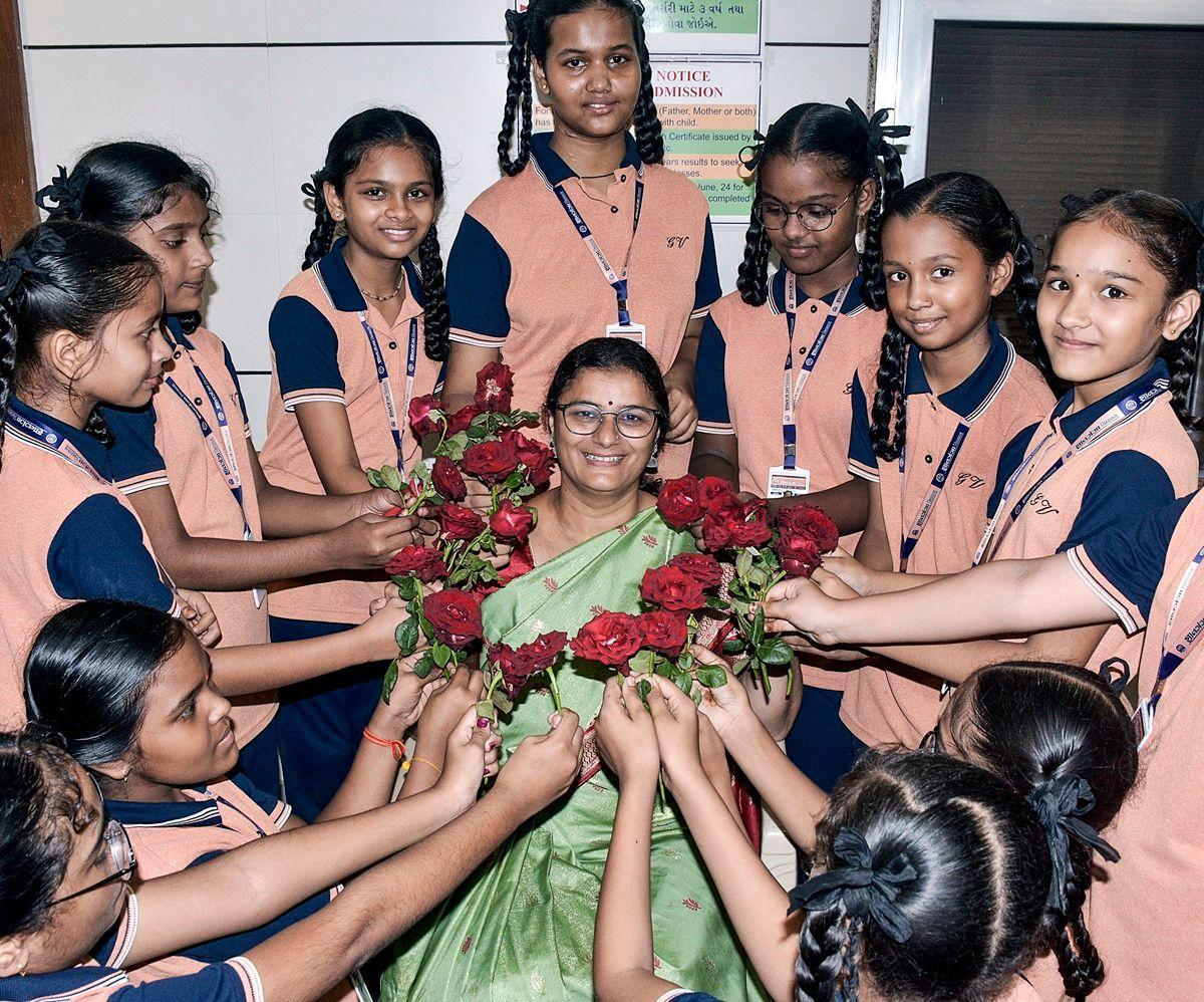 Students give flowers to their teacher on the occasion of Teachers' Day Students give flowers to their teacher on the occasion of Teachers' Day
