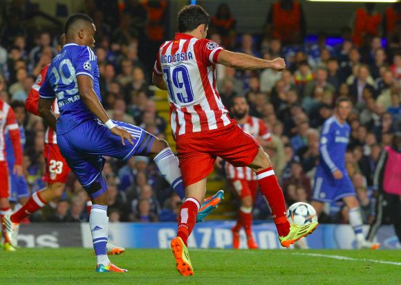 Chelsea's Samuel Eto'o fouls Diego Costa of Atletico Madrid