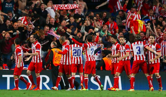 Atletico Madrid players celebrate after winning the game