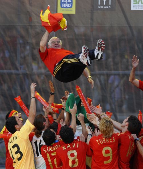The Spanish team throw their manager Luis Aragones into the air while celebrating with fans at Plaza Colon after winning the UEFA EURO 2008 Final 