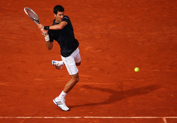 Novak Djokovic of Serbia returns a shot during his men's singles match against Milos Raonic of Canada