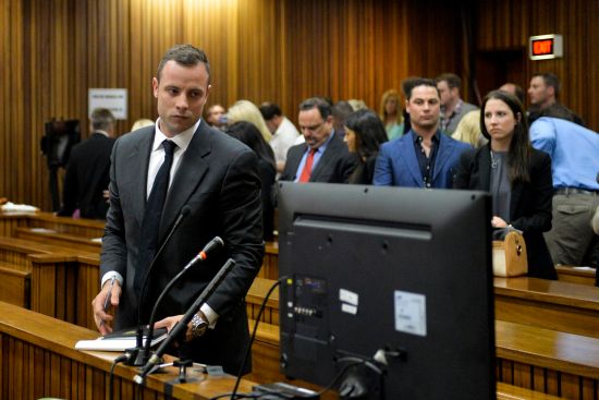 Olympic and Paralympic track star Oscar Pistorius stands in the dock during his trial for the murder of his girlfriend Reeva Steenkamp,