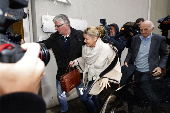 Corinna Schumacher (C), wife of former Formula One world champion Michael Schumacher, and Professor Gerard Saillant (R), president of the Institute for Brain and Spinal Cord Disorders (ICM), arrive at the CHU hospital emergency unit where Schumacher is hospitalized