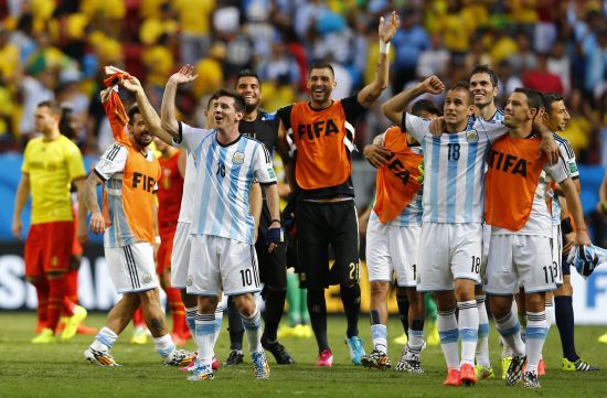 Argentina's Lionel Messi and teammates celebrate winning the 2014 World Cup quarter-finals between Argentina and Belgium