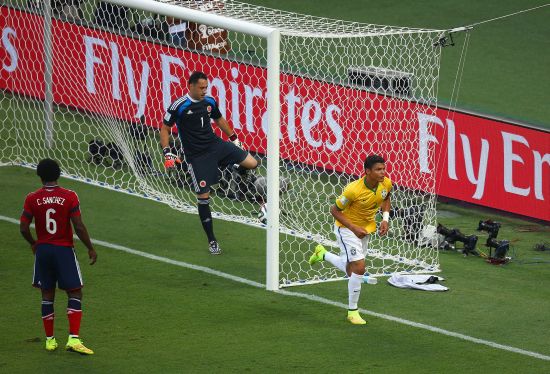 Brazil captain Thiago Silva celebrates after scoring his team's first goal past David Ospina of Colombia