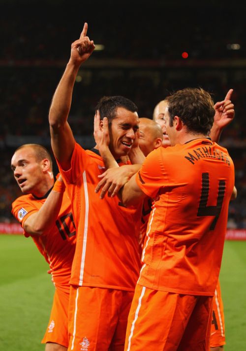 Giovanni Van Bronckhorst of the Netherlands celebrates scoring the opening goal with his Dutch team mates.