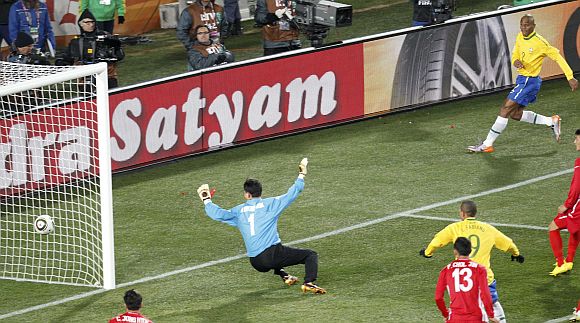 Brazil's Maicon (R) scores past North Korea's goalkeeper Ri Myong-guk