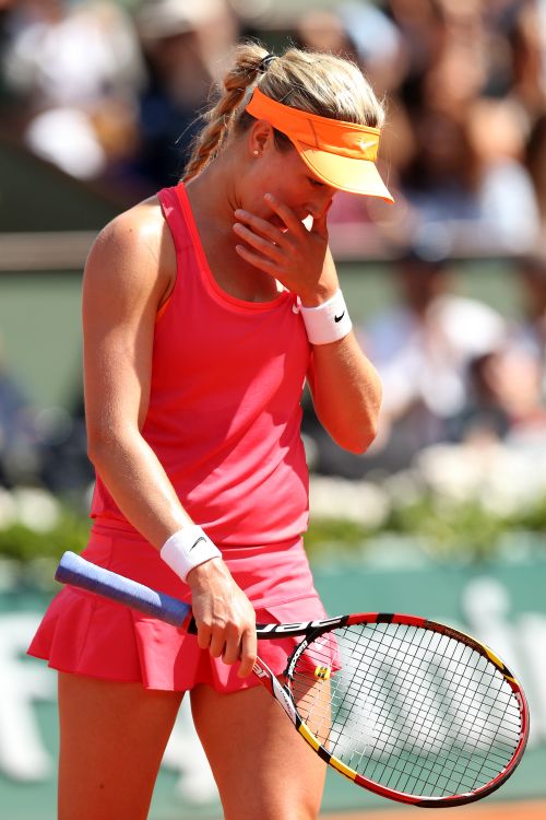 Eugenie Bouchard reacts after missing out on a point during the semi-final match against Maria Sharapova