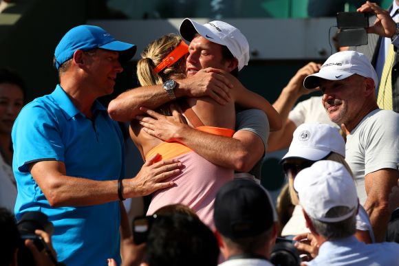 Maria Sharapova of Russia celebrates with her team following her victory in her women's singles final match against Simona Halep of Romania 