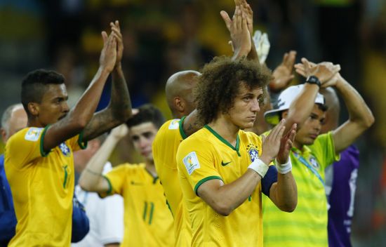 Brazil's Luiz Gustavo (L), David Luiz (C) and Thiago Silva (rear R) acknowledge the crowd after their 2014 World Cup semi-finals against Germany 