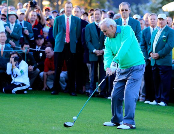 Honorary starter Arnold Palmer hits a tee shot on the first hole at the start of the first round of the 2014 Masters Tournament 