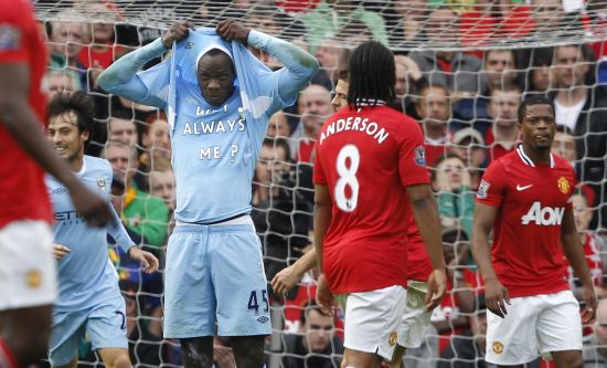 Manchester City's Mario Balotelli celebrates after scoring the opening goal against Manchester United during their English Premier League soccer match at Old Trafford 