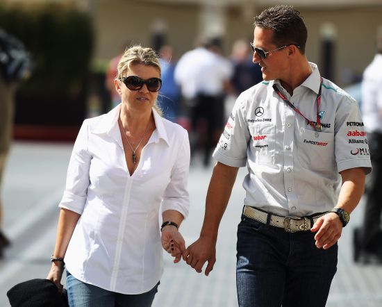 Michael Schumacher of Germany and Mercedes GP walks with his wife Corrina