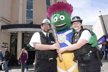 In this handout image provided by Glasgow 2014 Ltd, mascot Clyde poses with PC Louise Seed (left) and Sergeant Steven Lapsley and the Commonwealth Games Baton