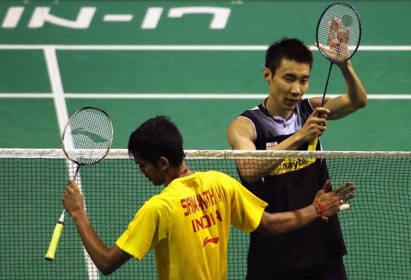 Malaysia's Lee Chong Wei (R) celebrates after defeating India's K. Srikanth