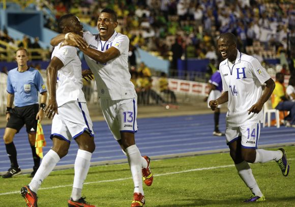 Honduras' Maynor Figueroa (L) celebrates with teammates Carlos Costly (C) and Garcia Oscar after scoring