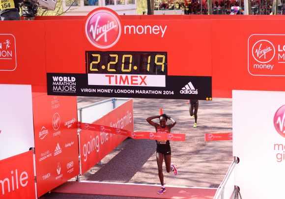 Edna Kiplagat crosses the finish line to win the women's elite race at the Virgin London Marathon 