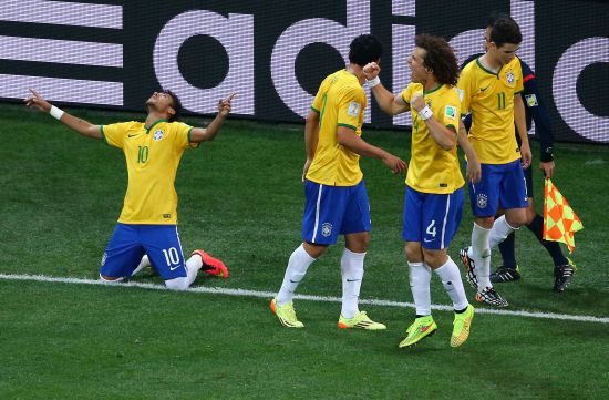 Neymar of Brazil (left) celebrates after scoring with teammates during the 2014 FIFA World Cup Brazil Group A match against Croatia at Arena de Sao Paulo