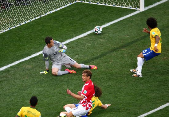 Julio Cesar (left) watches helplessly as Marcelo deflectes the ball into Brazil's goal.