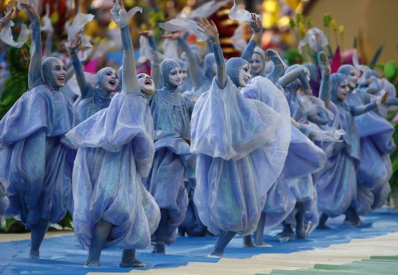 Performers participate in the opening ceremony of the 2014 World Cup at the Corinthians arena in Sao Paulo