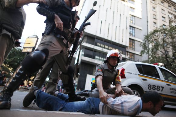 A demonstrator is detained after clashes with police during a protest against the 2014 World Cup in Porto Alegre