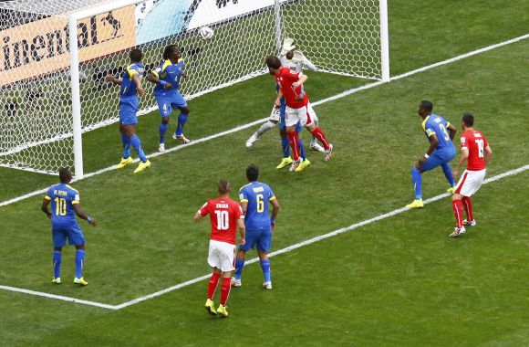Switzerland's Admir Mehmedi (centre, in red) heads to score against Ecuador