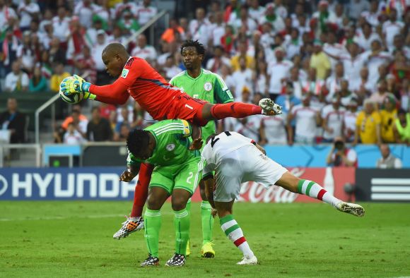 incent Enyeama of Nigeria makes a save over teammates Joseph Yobo and Ashkan Dejagah of Iran 