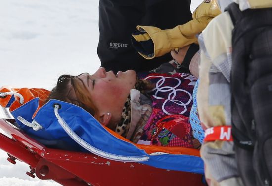 Jacqueline Hernandez of the U.S. lies on a stretcher after crashing during the women's snowboard cross qualification round 