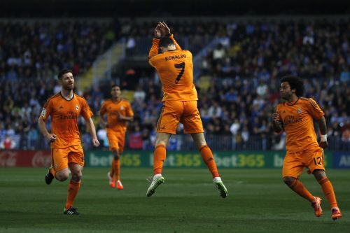 Real Madrid's Cristiano Ronaldo (C) celebrates after scoring a goal against Malaga