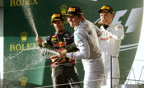 Winner Mercedes Formula One driver Nico Rosberg of Germany (C) sprays champagne as he celebrates beside second-placed Red Bull Formula One driver Daniel Ricciardo of Australia (L) and third-placed McLaren Formula One driver Kevin Magnussen of Denmark after the Australian F1 Grand Prix