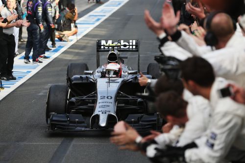 Kevin Magnussen of Denmark and McLaren celebrates as he drives into parc ferme after finishing third during the Australian Formula One Grand Prix 