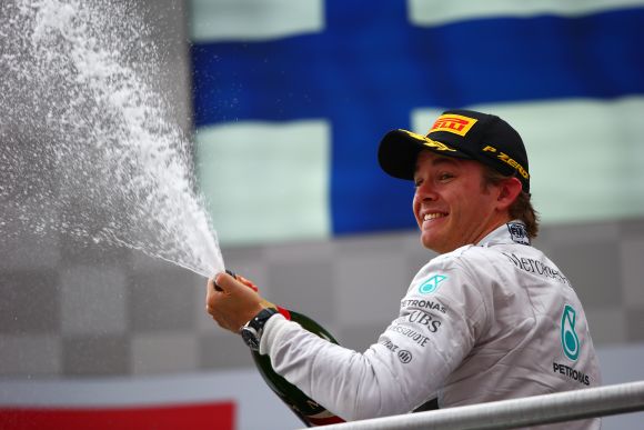 Nico Rosberg of Germany and Mercedes GP celebrates on the podium after victory in the German Grand Prix 