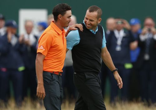 Rickie Fowler of the U.S. (L) walks with Sergio Garcia of Spain on the 18th green after they finished as joint runners-up in the British Open Championship 
