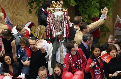 Arsenal manager Arsene Wenger lifting the Premiership trophy during Arsenal's open top bus parade 