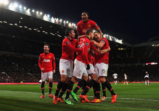 Manchester United players celebrate after scoring a goal