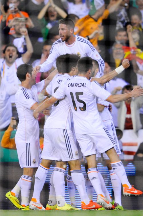Real Madrid players celebrate after scoring a goal