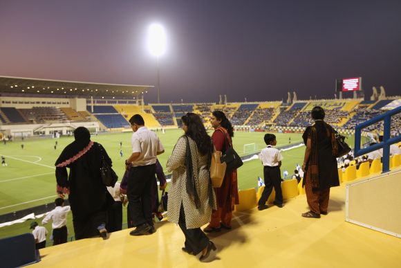 Fans watch a game in Qatar