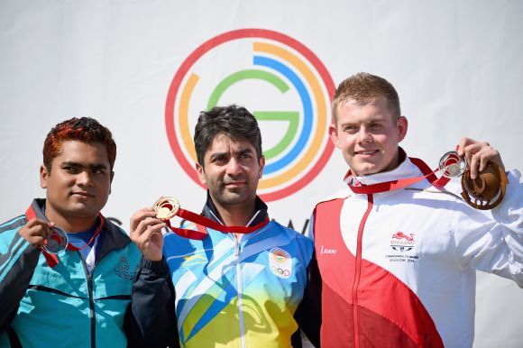 Abdulah Baki of Bangladesh, Abhinav Bindra of India and Daniel Rivers of England, receive their medals following competing in the mens 10m Air Rifle at Barry Buddon Shooting Centre during day two of the Glasgow 2014 Commonwealth Games