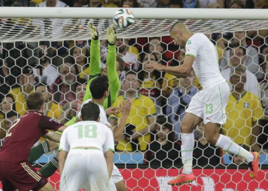 Algeria's Islam Slimani (right) heads the ball to score against Russia
