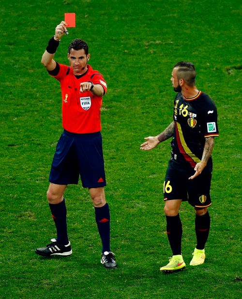 Referee Benjamin Williams shows the red card to Steven Defour of Belgium