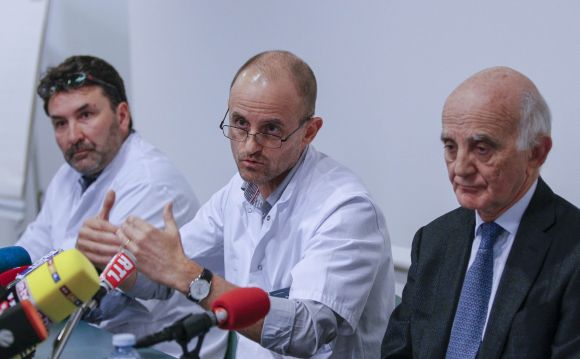 Jean-Francois Payen (C), head anaesthetician at the CHU hospital, neurosurgeon Stephan Chabardes (L) and Professor Gerard Saillant, President of the Institute for Brain and Spinal Cord Disorders (ICM), attend a news conference at the CHU Nord hospital emergency unit in Grenoble
