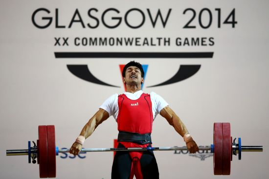 Omkar Otari of India competes in the Men's 69kg weightlifting final at the Clyde Auditorium 