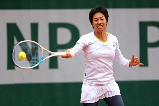 Kimiko Date-Krumm of Japan returns a shot during her women's singles match against Anastasia Pavlyuchenkova of Russia 
