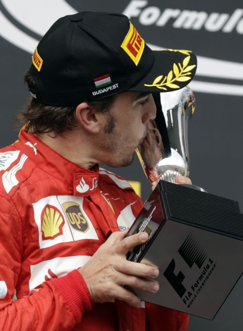 Second placed Ferrari Formula One driver Fernando Alonso of Spain kisses his trophy