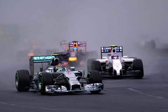 Nico Rosberg of Germany and Mercedes GP leads Valtteri Bottas of Finland and Williams and Sebastian Vettel of Germany and Infiniti Red Bull Racing into turn two during the Hungarian Formula One Grand Prix